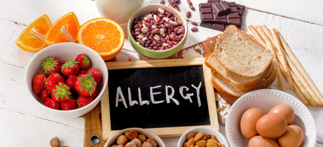 Food allergy. Allergic food on wooden background.